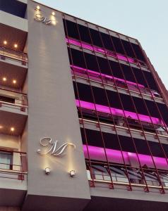 a building with a neon sign on the side of it at Hotel Makedonia in Veria