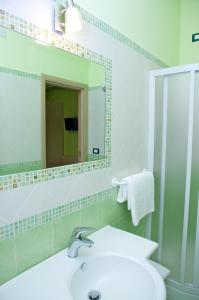 a bathroom with a sink and a mirror at Il Fiore di San Giovanni B&B in Milazzo