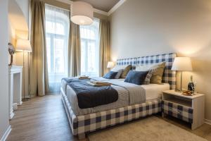 a bedroom with a bed with a blue and white at H75 Apartments Kosice Centre in Košice