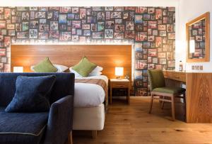 a hotel room with a bed and a desk and a chair at ABode Canterbury in Canterbury