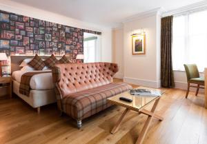 a hotel room with a bed and a couch at ABode Canterbury in Canterbury