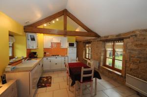 a kitchen with a table and chairs in it at Gite THEYS Floing in Floing