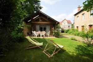 two lawn chairs and a table in a yard at Gite THEYS Floing in Floing