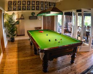 a pool table with balls on it in a living room at Mountain Whispers Chatelaine Valley in Katoomba