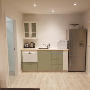 a kitchen with a sink and a refrigerator at Near the shore in Waikanae +7 photos