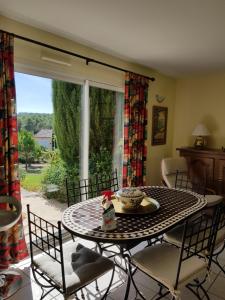 a dining room with a table and chairs and a window at Studio Villa Les Canas in Saint-Gély-du-Fesc