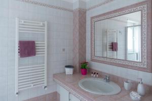a bathroom with a sink and a mirror at Terrazza Sui Colli in Monopoli +37 photos