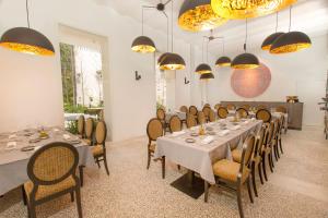 a dining room with tables and chairs and lights at ICON Rosetó in Palma de Mallorca