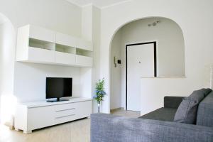 a living room with a couch and a tv at EasySleep - Ostia in Lido di Ostia