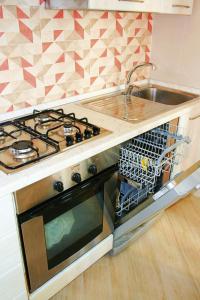 A kitchen or kitchenette at EasySleep - Ostia