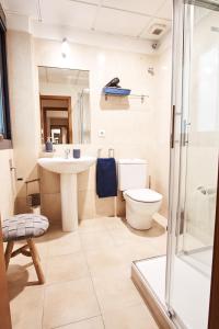 a bathroom with a toilet and a sink and a shower at Setefilla Deluxe Suite by Valcambre in Seville