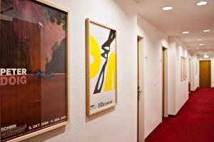 a corridor of halls with posters on the walls at The Corner Hotel in Frankfurt