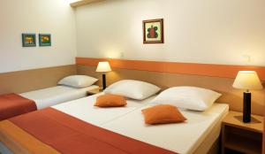 Postel nebo postele na pokoji v ubytování Garni Hotel Savica - Sava Hotels & Resorts