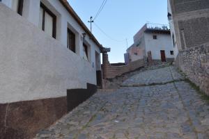 a cobblestone street with stairs next to a building at Hostería Chez DidierM in Iruya