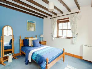 A bed or beds in a room at Mews End Cottage 