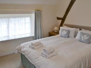 A bed or beds in a room at Lythe Cottage 