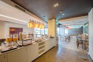 a restaurant with a counter with some food at Royal Pacific Hotel in Sydney