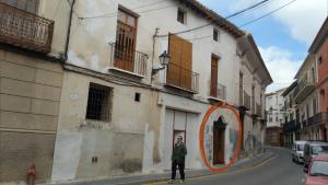 a man standing on a street in front of a building at Apartamento en casco antiguo Moratalla in Moratalla