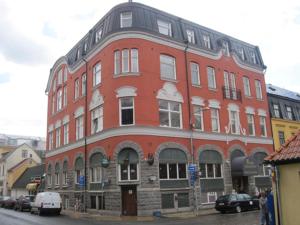 a large red brick building on a city street at Hotell Kong Christian in Kristianstad