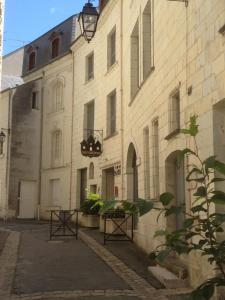 a large white building with a street in front of it at Hôtel St Pierre in Saumur