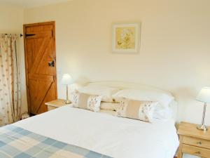 A bed or beds in a room at The Cowshed 