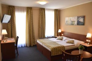 מיטה או מיטות בחדר ב-Aparthotel Austria Suites