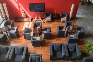 a room with couches and tables and a flat screen tv at Hotel Les Torres in Martorell