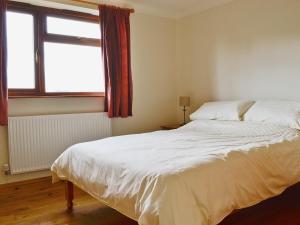 A bed or beds in a room at The Ferns 