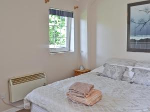 A bed or beds in a room at Cornhill Hall Lodge 