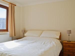 A bed or beds in a room at The Ferns 