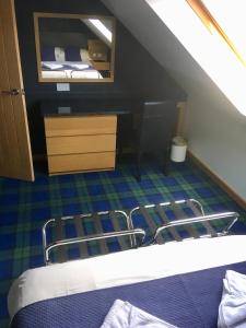 a bedroom with a bunk bed and a mirror at Maol View Apartment in Kyleakin