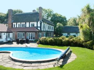 a swimming pool in the yard of a house at Silverland in Hordle