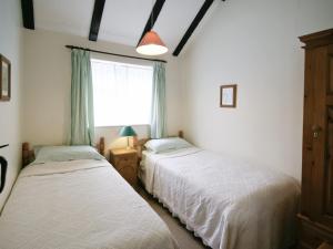 A bed or beds in a room at The Coach House II 