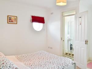 A bed or beds in a room at The Boathouse II 