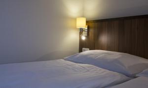 Postel nebo postele na pokoji v ubytování Hotel Selsky Dvur