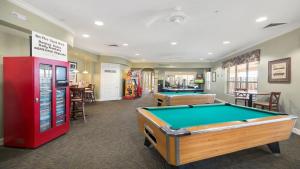 a billiard room with a pool table and a machine at Disney Bunk Room--Windsor Hills in Orlando