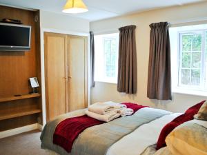 A bed or beds in a room at The Old Mill 