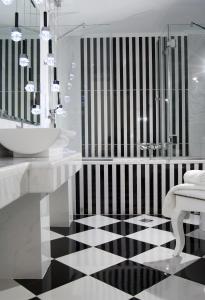 a bathroom with a black and white checkered floor at Acropolis Museum Boutique Hotel in Athens