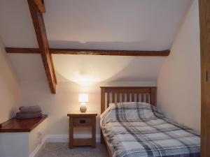 A bed or beds in a room at The Coach House 