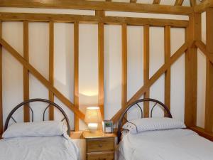 A bed or beds in a room at Rushfields Barn 