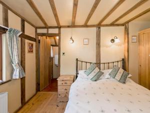 A bed or beds in a room at The Old Stable 