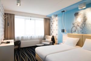 Postel nebo postele na pokoji v ubytování ibis Styles Haarlem City