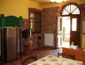 eine Küche mit einem Tisch und einem Kühlschrank in der Unterkunft Il Frantoio - a in Lucca