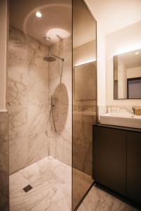 a bathroom with a shower and a sink at Charlie's Bed & Breakfast in Antwerp