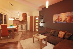 a living room and kitchen with a couch and a table at Apartments Elena in Ohrid