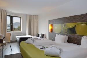 Tempat tidur dalam kamar di Mercure Hotel Koblenz