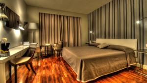 Letto o letti in una camera di Hotel Datini