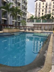a large swimming pool in front of a building at Palm Tree Villas 1 in Manila