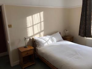 a bedroom with a white bed and a window at Seventeen Latham in Preston