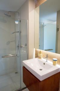 a bathroom with a sink and a glass shower at The Bleu condo unit in Chaweng